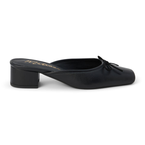 Elegant black mule heels with a square toe and small bow detail, featuring a comfortable block heel for versatile day-to-night wear.