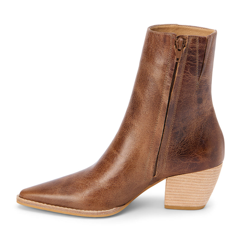 Distressed brown leather ankle boots with a pointed toe, stacked block heel, and vintage-inspired finish. A modern take on a classic Western silhouette, perfect for effortless everyday wear.