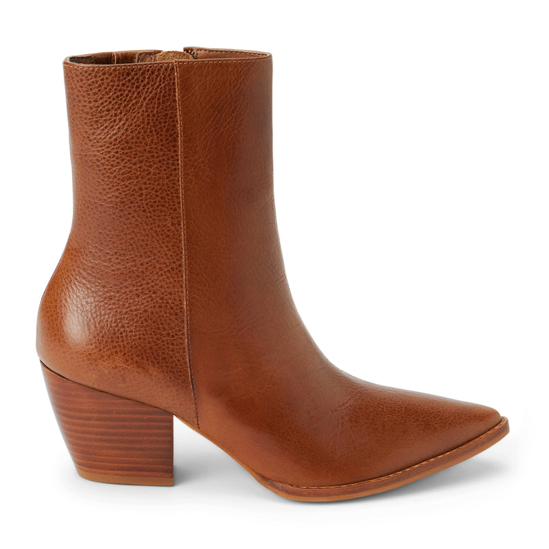 Tan leather ankle boots featuring a pointed toe, stacked block heel, and smooth side panels. A refined take on a Western-inspired silhouette.