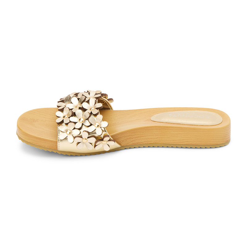 Gold floral-embellished slide sandals with a faux-wood platform sole and metallic daisy appliqués. A playful yet refined style, perfect for effortless warm-weather wear.