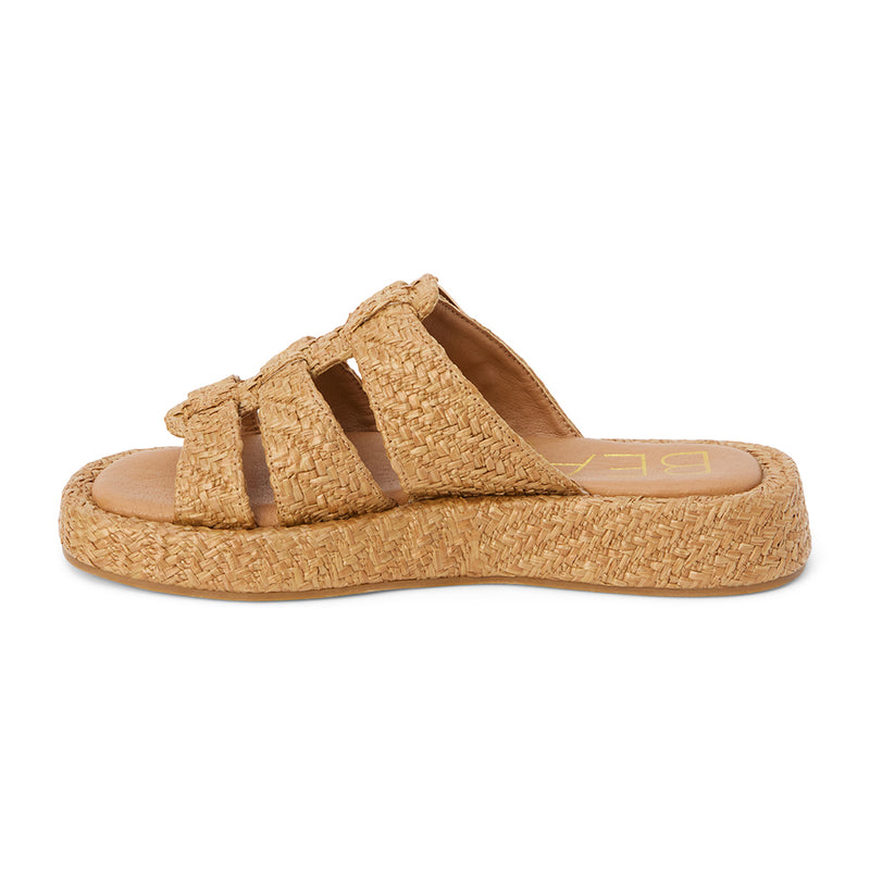 Tan raffia platform slide sandals with woven straps and an adjustable buckle detail. A breezy, laid-back style perfect for warm-weather wear.