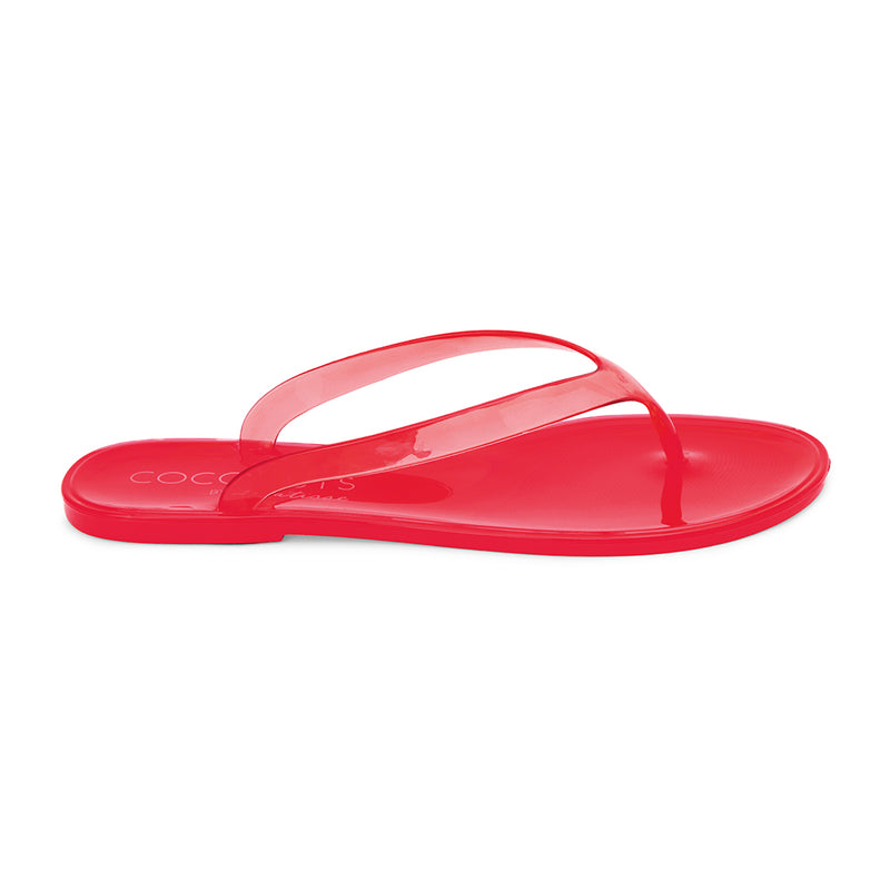 Red jelly flip-flops with transparent straps and a minimalist design. A lightweight, water-friendly essential for effortless summer wear.