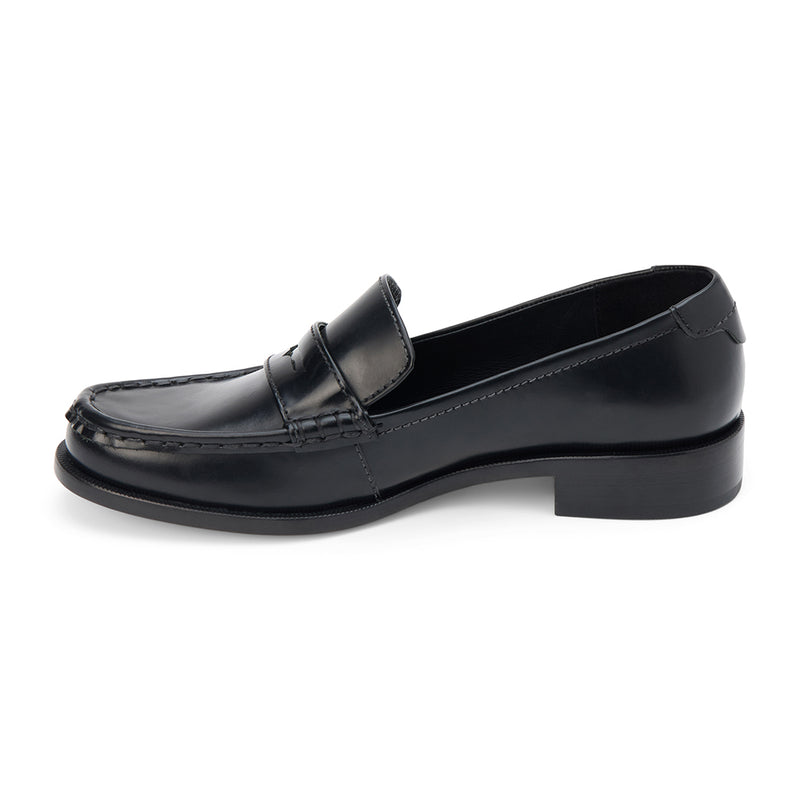 Black leather penny loafers with a polished finish, classic moccasin stitching, and a low stacked heel. A timeless staple for effortless sophistication.